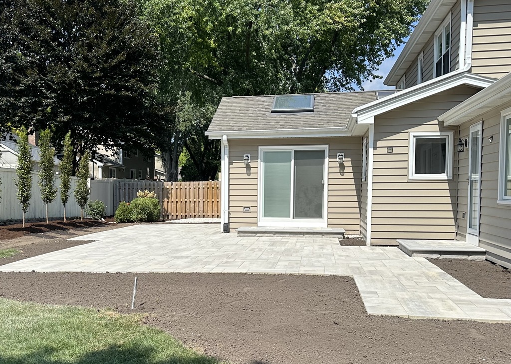 Multi-level Unilock paver patio with integrated fire pit in Will-O-Way, Naperville.